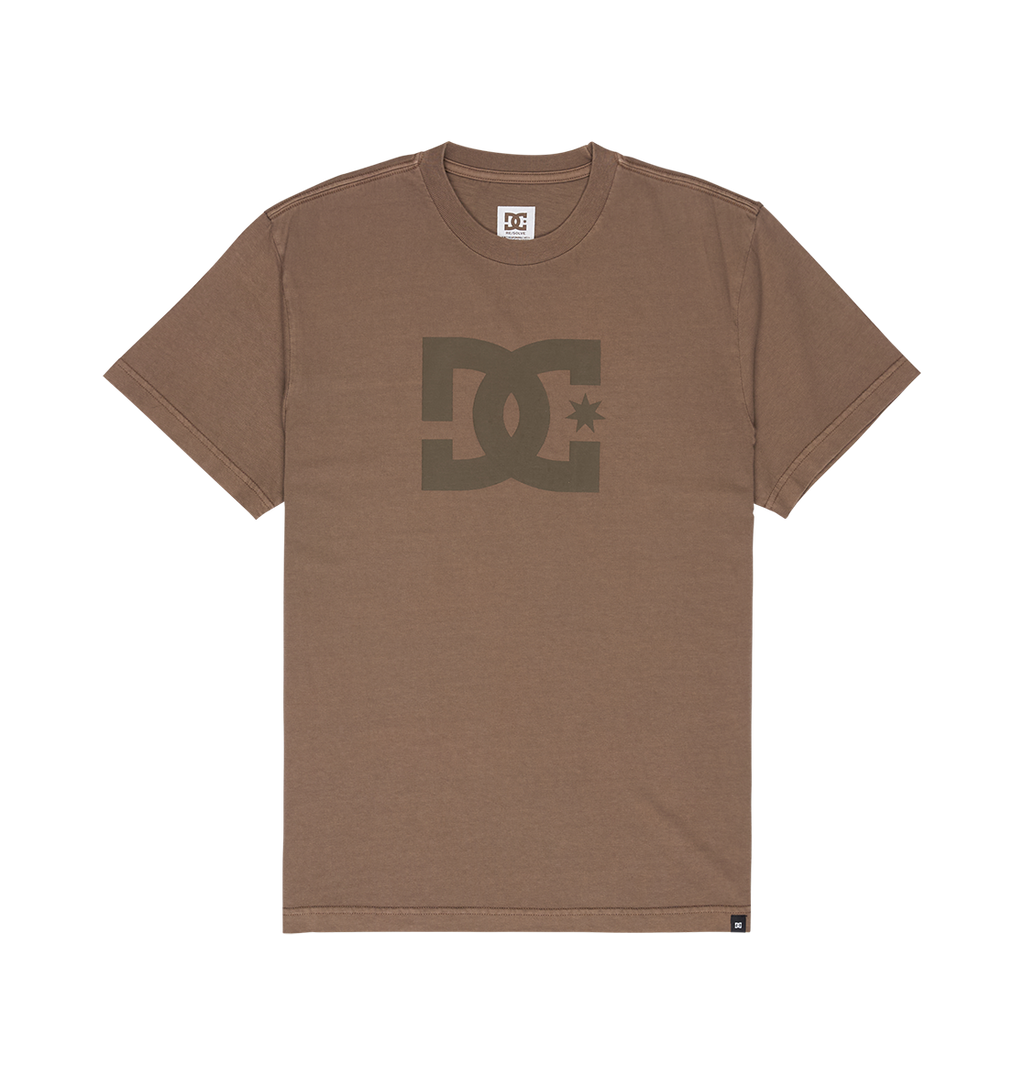 Men's DC Star Pigment Dye Tee by DC Shoes in brown, featuring short sleeves, a prominent dark brown DC Shoes logo and signature DC artwork on the chest, displayed against a plain white background.