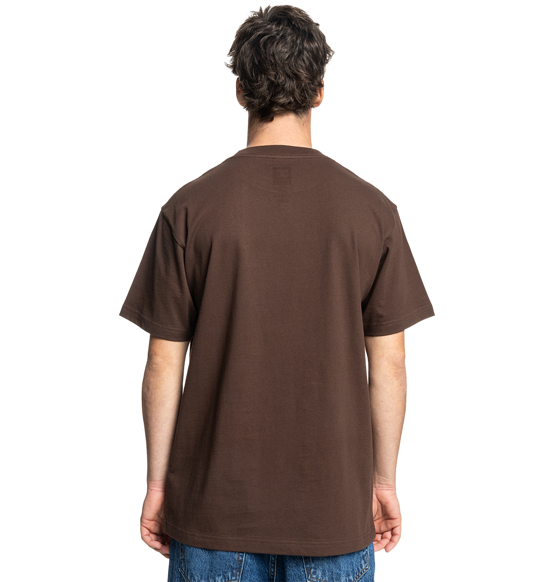 A person with short, dark hair faces away, wearing the Men's DC Star Pocket Tee by DC Shoes—a relaxed fit brown skate shirt in soft cotton—paired with blue jeans against a light gray background.