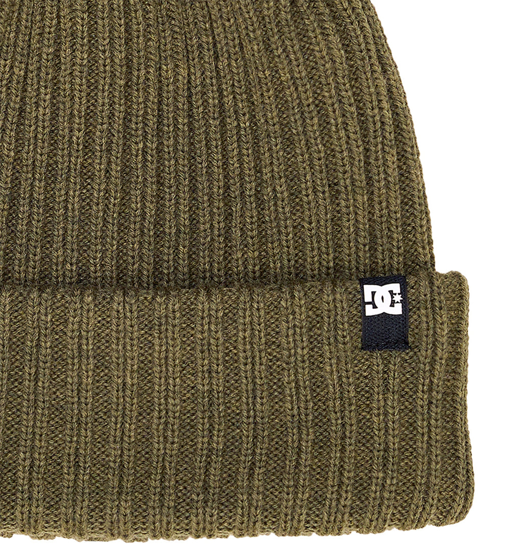 Detailed close-up of the olive green DC Shoes Fish N Destroy 2 knit beanie, showcasing its ribbed texture and folded brim. Made from recycled fibers, this beanie is finished with a small black and white DC Shoes logo tag sewn onto the right side of the brim.