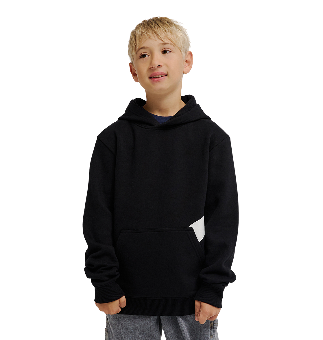 A young boy with short blond hair wears the DC Shoes Lanai Hoodie Youth pullover, featuring DC graphics, fleece warmth, and a front pocket. He pairs it with light pants and stands smiling against a plain white background.