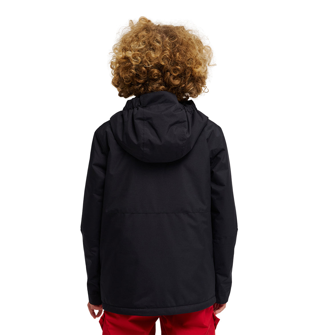 A person with curly hair is seen from behind, wearing the DC Shoes Basis Youth Jacket in black and red pants, standing against a white background.