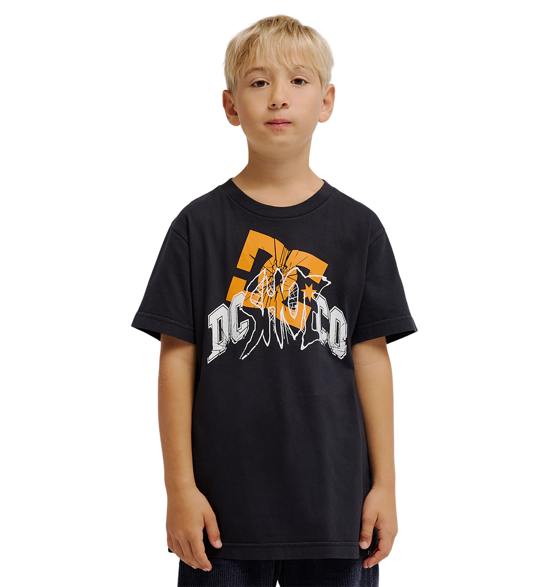 A young boy with blonde hair wears the DC Shoes Speratic Tee Youth, a black graphic skate t-shirt with bold orange and white designs, standing against a plain white background.