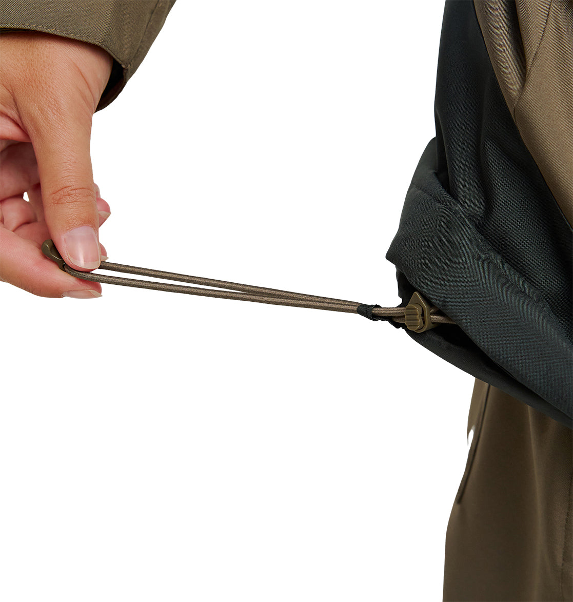 A person’s hand pulls an adjustable drawstring at the hem of the olive green DC Shoes Everfrost Jacket, tightening the fit around the waist.