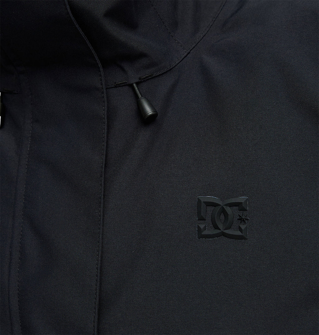 Close-up of the DC Shoes Cruiser Jacket in black, featuring subtle embossed branding on the chest and a drawstring with a plastic tip near the collar.