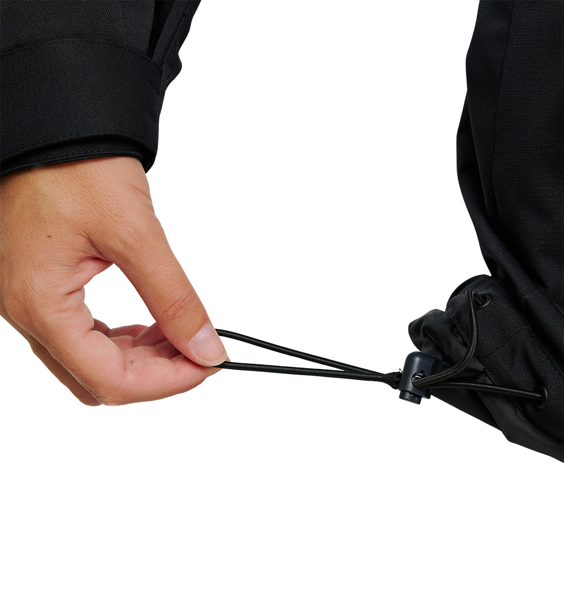 A hand is pulling the elastic drawcord on the hem of a black DC Shoes Cruiser Jacket, adjusting the fit with a plastic toggle.