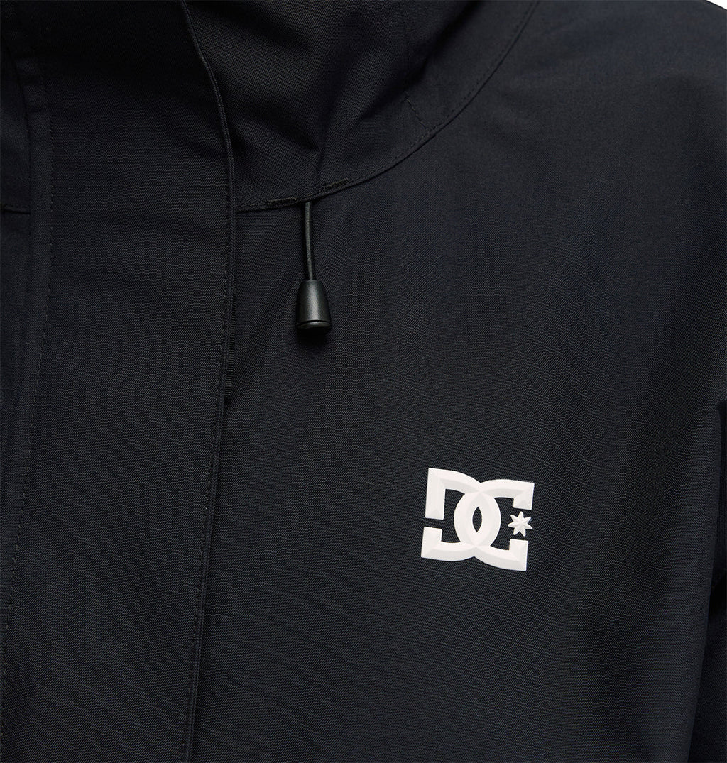 Close-up of the DC Shoes Cruiser Jacket in black, featuring a white DC Shoes logo on the chest and a drawstring with a black plastic end visible near the logo.