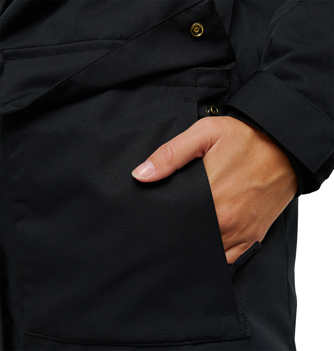 A close-up of a person wearing the DC Shoes Cruiser Jacket, with their right hand placed inside the jacket pocket. Only the hand and details of the Cruiser Jacket pocket are visible.