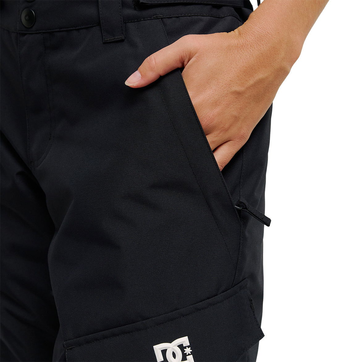 A person is shown against a white background, with only part of their torso and right hand—tucked into the front pocket—visible while wearing black DC Shoes Nonchalant Pants. The image draws attention to the pants’ premium waterproofing designed for outstanding snow performance.