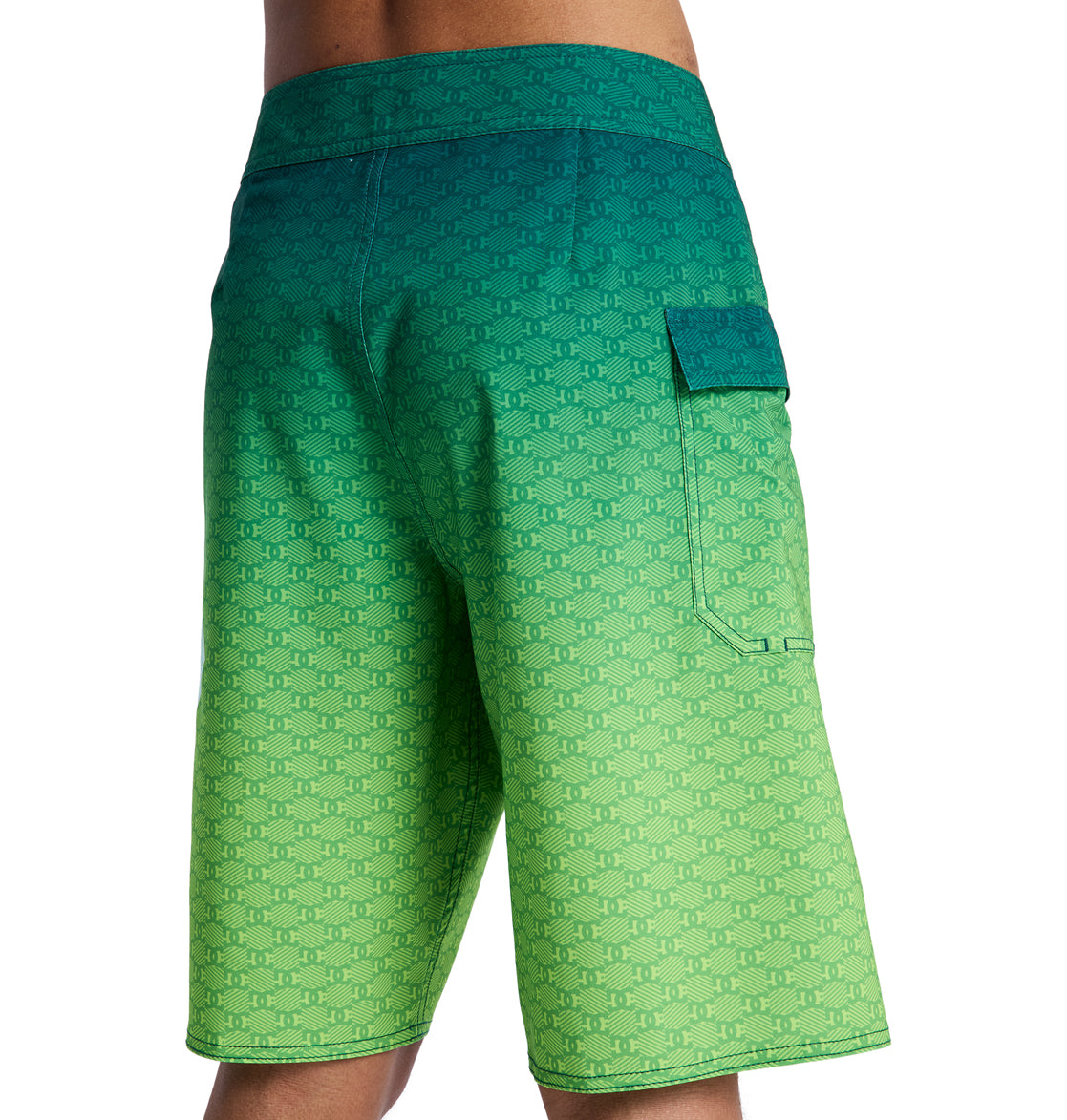 A person shown from the back wearing Reebok Lanai 21 board shorts featuring a green and blue gradient, subtle repeating pattern, and a right-side flap pocket.