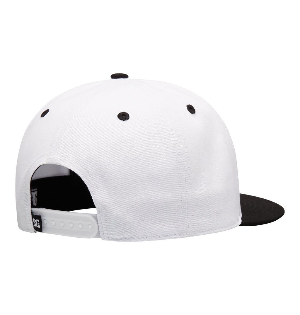 The Reebok DC Double That Cap is a white snapback with a black brim, black ventilation eyelets, and an adjustable white plastic strap, shown from the back.