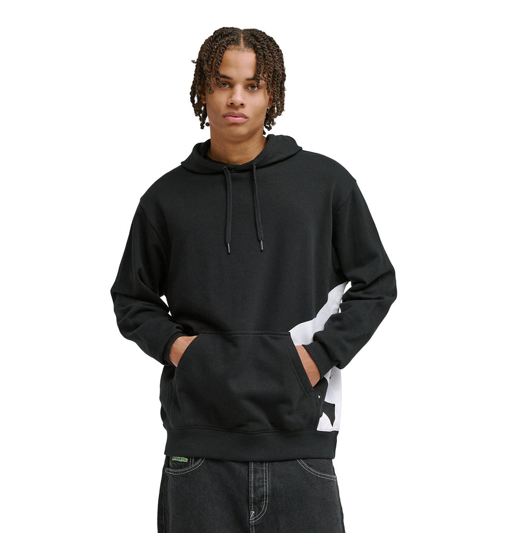 A young man with short, braided hair wears the DC Shoes Lanai Ph black hoodie with a front pocket and subtle white graphic on the side, standing with hands in the pocket and facing forward.