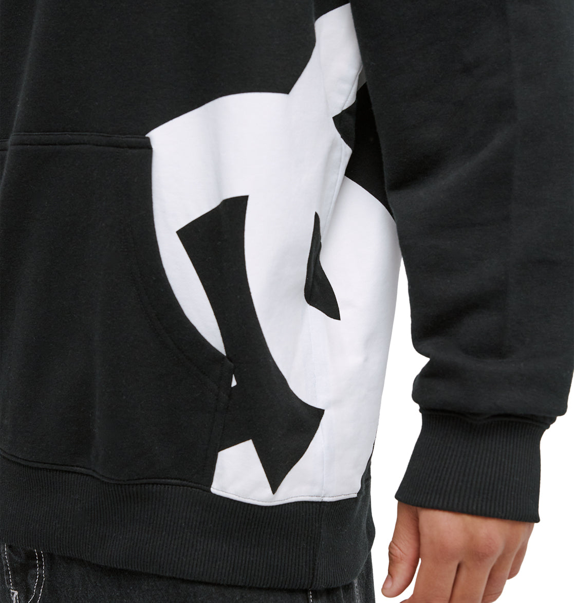 A person wearing the Reebok Lanai Ph sweatshirt in black with a bold white and black abstract side design, standing with one arm relaxed. Only the torso and arm are visible.