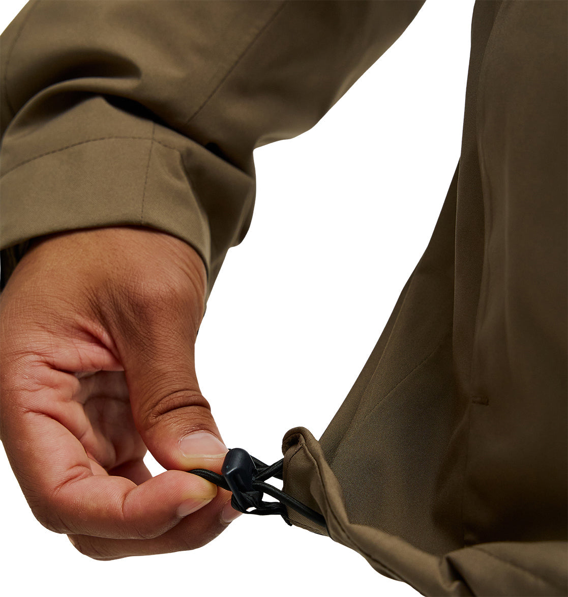 A hand tightens a black drawstring toggle on the hem of the brown DC Shoes Edge Jacket 20K, adjusting the fit.