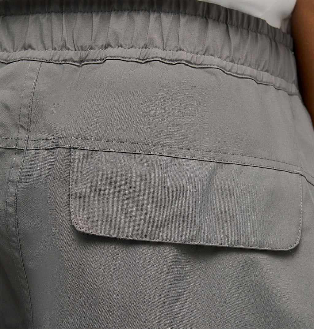 Close-up of the back pocket of the DC Shoes Smoke Pants 10K in gray, featuring an elastic waistband and flap closure for breathable protection and optimal comfort.